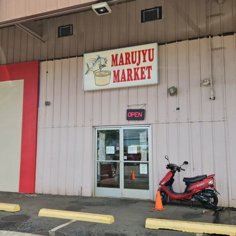 The Marujyu Market sign above the front door, with the OPEN sign lit